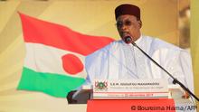 Niger's President Mahamadou Issoufou delivers a speech as he takes part with France's President in a military ceremony at the Martyr Quarter on December 22, 2019, in Niamey, to pay homage to 71 Nigerien soldiers massacred in an attack on December 10 at the Inates military camp in the Sahel country's western Tillaberi region. (Photo by Ludovic MARIN / POOL / AFP)