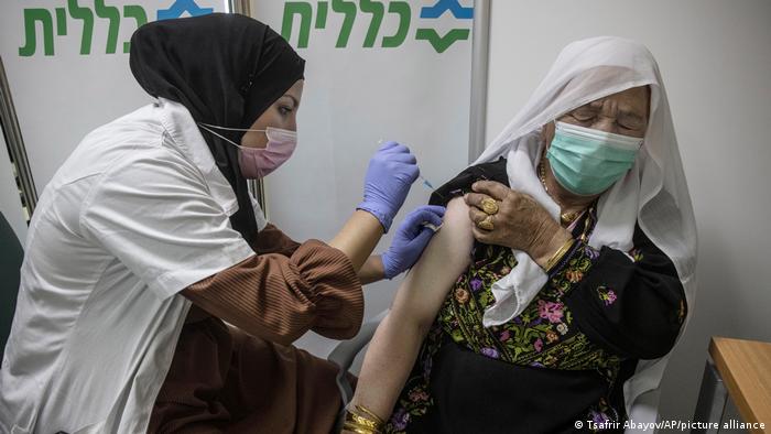 A woman receives the BioNTech-Pfizer vaccine in Segev Shalom. 