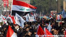 Iraqis, including supporters of Hashid Shaabi (Popular Mobilization Forces), hold flags during a gathering to mark the one year anniversary of the killing of senior Iranian military commander General Qassem Soleimani and Iraqi militia commander Abu Mahdi al-Muhandis in a U.S. attack, in Baghdad, Iraq January 3, 2021. REUTERS/Khalid Al-Mousily