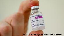 A vial of the COVID-19 vaccine developed by Oxford University and U.K.-based drugmaker AstraZeneca is checked as they arrive at the Princess Royal Hospital in Haywards Heath, England, Saturday Jan. 2, 2021. The UK has 530,000 doses available for rollout from Monday. (Gareth Fuller/Pool via AP)