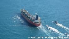 In this photo released Monday, Jan. 4, 2021, by Tasnim News Agency, a seized South Korean-flagged tanker is escorted by Iranian Revolutionary Guard boats on the Persian Gulf. Iranian state television acknowledged that Tehran seized the oil tanker in the Strait of Hormuz. The report on Monday alleged the MT Hankuk Chemi had been stopped by Iranian authorities over alleged “oil pollution” in the Persian Gulf and the strait. (Tasnim News Agency via AP)