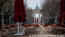 Abandoned cafe chairs and tables are seen on the deserted Unter den Linden boulevard leading up to landmark Barandenburger Gate in Berlin, on January 5, 2021 amid the ongoing novel coronavirus / COVID-19 pandemic. - German Chancellor Angela Merkel and state leaders are expected Tuesday, January 5, 2021 to extend a partial lockdown in Europe's top economy as coronavirus deaths continue to mount despite tough restrictions in the run-up to the holidays. (Photo by Odd ANDERSEN / AFP) (Photo by ODD ANDERSEN/AFP via Getty Images)