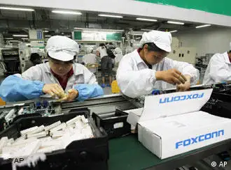 Staff members work on the production line at the Foxconn complex in the southern Chinese city of Shenzhen, Southern city in China, Wednesday, May 26, 2010. The head of the giant electronics company whose main facility in China has been battered by a string of worker suicides opened the plant's gates to scores of reporters Wednesday, hours after saying that intense media attention could make the situation worse. (AP Photo/Kin Cheung)