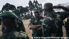 Congolese Army General Philemon Yav (2n R) reviews the soldiers during an official visit to Bijombo, South Kivu Province, eastern Democratic Republic of Congo, on October 10, 2020. - Since February 2019, the landlocked highlands of Fizi and Uvira in South Kivu have been the scene of clashes and retaliation attacks by armed groups claiming to defend the interests of their respective communities. According to the United Nations High Commissioner for Human Rights, approximately one hundred villages have been destroyed and burned, several dozen civilians have been killed and thousands of people have been forced to flee their homes. (Photo by ALEXIS HUGUET / AFP) (Photo by ALEXIS HUGUET/AFP via Getty Images)