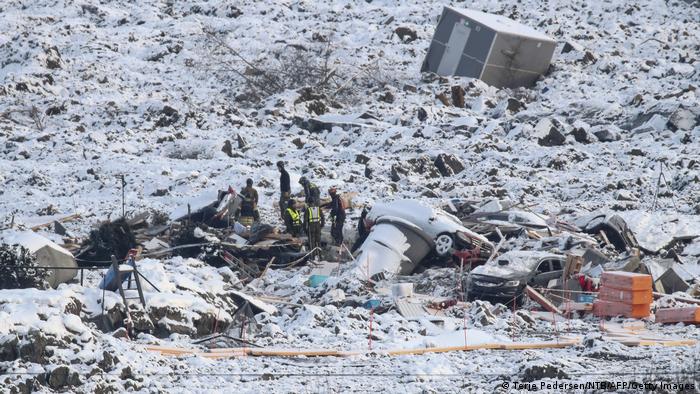Rescuers search through the rubble at the landslide site