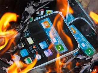 cardboard picture of an iphone set on fire
