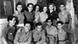 A group of children and youth stand and squat in rows in a black and white photo A group of children and youth stand and squat in rows in a black and white photo