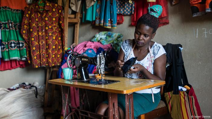 A woman uses a sewing machine to make a corona protective mask in Mpigi, Uganda