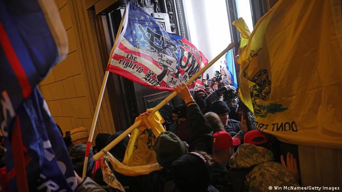 Protesters storm the doors of the Capitol