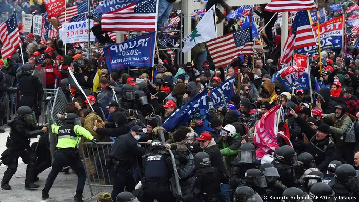 Dozens of US flags wave as Trump supporters clash with police and security forces as they push barricades to storm the US Capitol on January 6, 2021.