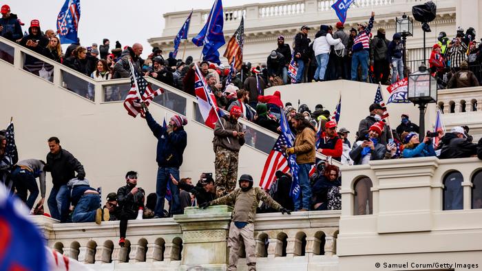 Protesters storm the stairs of the US Capitol