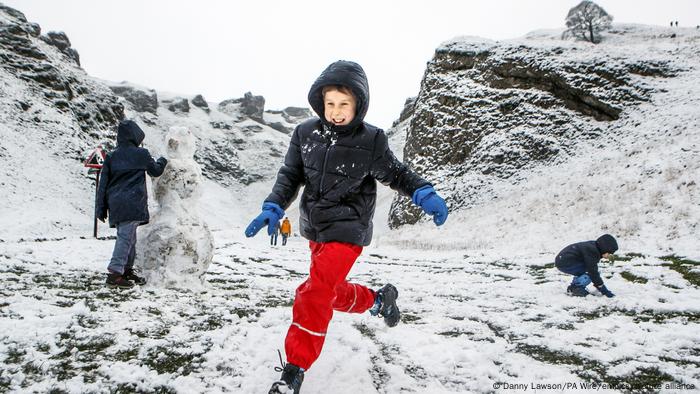 Young children play in the snow in England