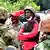 Ugandan presidential candidate Bobi Wine surrounded by supporters and security officials