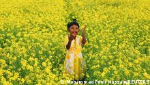 08.01.2020 *** A girl plays in a mustard field in Munshiganj, Bangladesh January 8, 2021. REUTERS/Mohammad Ponir Hossain TPX IMAGES OF THE DAY