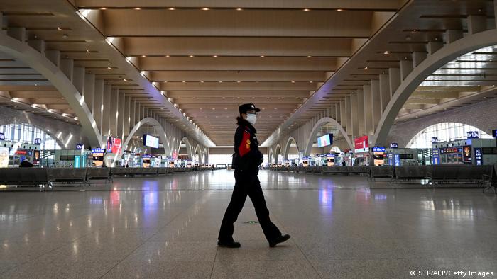 A police patrol walking at an empty railway station in China's Hebei Province.