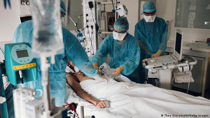 Medical professionals treating a patient in an ICU ward