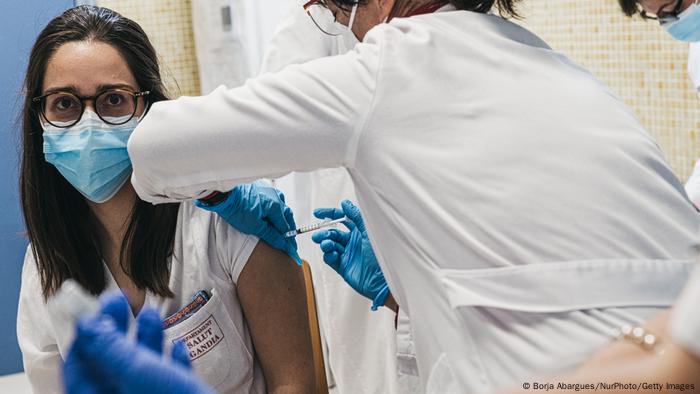 A young woman receives her BioNTech-Pfizer vaccine in Valencia, Spain