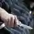  A hand holding a butterfly knife