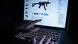 A man points to the webpage of an online shop that sells machine guns on the Darknet A man points to the webpage of an online shop that sells machine guns on the Darknet