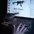 A man points to the webpage of an online shop that sells machine guns on the Darknet