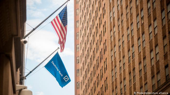 The American flag hangs outside the Deutsche Bank headquarters on Wall Street in New York City.