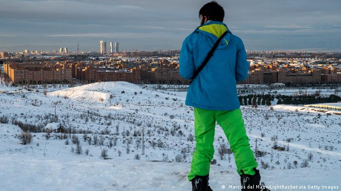 Hombre ante paisaje nevado de Madrid.