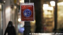 Ein Schild, das auf die Maskenpflicht hinweist, hängt in der Innenstadt. Bundeskanzlerin Merkel und die Regierungschefs der Länder wollen am Dienstag (19.01.2020) über eine mögliche Verschärfung der Lockdown-Regeln beraten. +++ dpa-Bildfunk +++