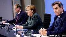 German Chancellor Angela Merkel, Bavarian State Premier Markus Soeder and Berlin Mayor Michael Mueller attend a news conference about further coronavirus disease (COVID-19) measures, at the Chancellery in Berlin, Germany, January 19, 2021. REUTERS/Hannibal Hanschke/Pool