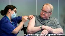 Nurse Maria Golding vaccinates Svein Andersen, in Oslo, Norway, Sunday, Dec. 27, 2020. Andersen, a resident of Ellingsrudhjemmet, was the first in Norway to receive the coronavirus vaccine. (Fredrik Hagen/NTB via AP)