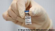 MOSCOW REGION, RUSSIA - JANUARY 21, 2021: A medical worker holds an ampoule with the first component of the Gam-COVID-Vak (Sputnik V) vaccine during a COVID-19 vaccination campaign at the Mega Khimki shopping center. Sergei Bobylev/TASS