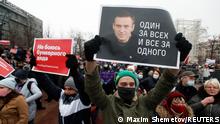 A participant holds a placard reading One for all, all for one during a rally in support of jailed Russian opposition leader Alexei Navalny in Moscow, Russia January 23, 2021. REUTERS/Maxim Shemetov