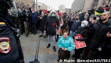 A participant is seen on her knees, near the law enforcement officers during a rally in support of jailed Russian opposition leader Alexei Navalny in Moscow, Russia January 23, 2021. REUTERS/Maxim Shemetov