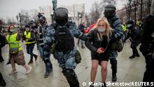 Law enforcement officers detain a woman during a rally in support of jailed Russian opposition leader Alexei Navalny in Moscow, Russia January 23, 2021. REUTERS/Maxim Shemetov