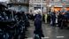 A woman stands in front of Russian riot police A woman stands in front of Russian riot police