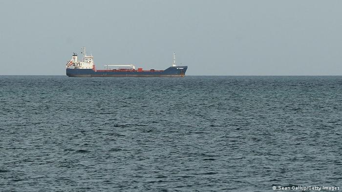 a picture of a container ship on the horizon
