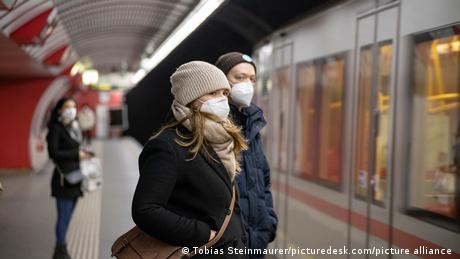 Passengers wearing FFP-2 masks in front of a train in Austria