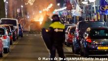 A large group of young people clash with police on Beijerlandselaan in Rotterdam, on January 25, 2021. - The Netherlands was hit by a second wave of riots on January 25 evening after protesters again went on the rampage in several cities following the introduction of a coronavirus curfew over the weekend. Riot police clashed with groups of protesters in the port city of Rotterdam, where they used a water canon. (Photo by Marco de Swart / ANP / AFP) / Netherlands OUT (Photo by MARCO DE SWART/ANP/AFP via Getty Images)