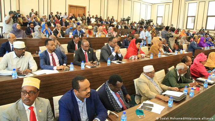 Dozens of lawmakers sit in rows in Somalia's parliament 
