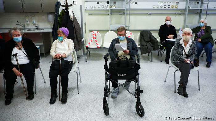 Senior citizens in an observation room after receiving a COVID-19 vaccination