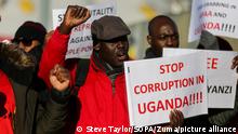January 20, 2020, London, United Kingdom: A Ugandan protester holds a placard that says Stop Corruption in Uganda!!!!' during a demonstration outside InterContinental Hotel in London Docklands as British Prime Minister Boris Johnson and Leaders of the African nations attend the UK-Africa Investment Summit 2020 in London Docklands..The protesters demand the release of Ugandan activist Stella Nyanzi who was jailed for harassing President Yoweri Museveni. (Credit Image: © Steve Taylor/SOPA Images via ZUMA Wire