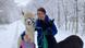 Black Forest, Germany, woman with two alpacas in a snow covered forest Black Forest, Germany, woman with two alpacas in a snow covered forest