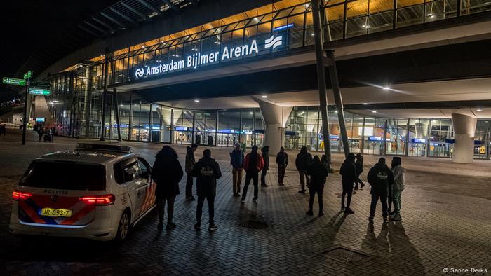 Police and others standing in front of the station in the Bijlmer in Amsterdam