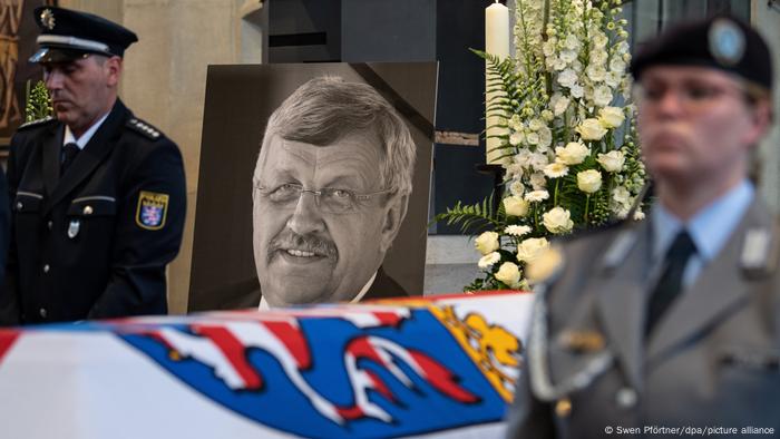 Walter Lübcke's funeral, showing his casket and a picture of him in the background. 