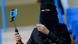 A Saudi woman football fan uses a "selfie" stick to film herself on her phone. A Saudi woman football fan uses a "selfie" stick to film herself on her phone.