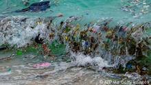 TOPSHOT - A wave carrying plastic waste and other rubbish washes up on a beach in Koh Samui in the Gulf of Thailand on January 19, 2021. (Photo by Mladen ANTONOV / AFP) (Photo by MLADEN ANTONOV/AFP via Getty Images)