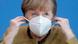 German Chancellor Angela Merkel removes a mask German Chancellor Angela Merkel removes a mask