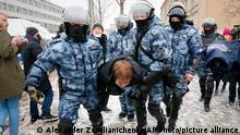 Police officers detain a man during a protest against the jailing of opposition leader Alexei Navalny in Moscow, Russia, on Sunday, Jan. 31, 2021. Thousands of people took to the streets Sunday across Russia to demand the release of jailed opposition leader Alexei Navalny, keeping up the wave of nationwide protests that have rattled the Kremlin. Hundreds were detained by police. (AP Photo/Alexander Zemlianichenko)