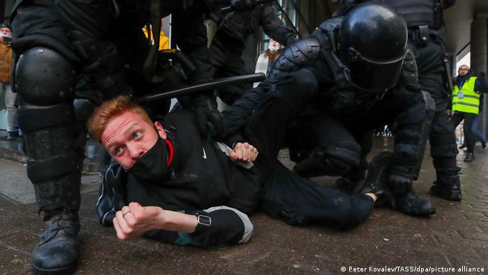 Riot police officers detain a demonstrator during an unauthorised protest in support of the detained opposition activist Alexei Navalny. 