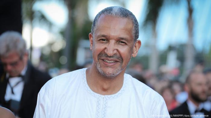 Abderrahmane Sissako , smiling man looks into camera 