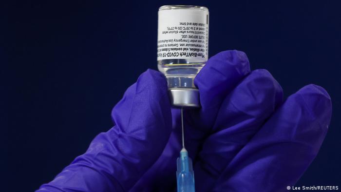 Healthworker draws syringe full of BioNTech- Pfizer vaccine